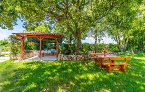 a picnic table and a gazebo in a yard at Apartment Krnica Iv in Krnica
