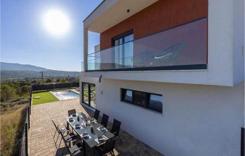 a balcony of a house with a table and chairs at Luxurious Home In Dicmo in Dicmo