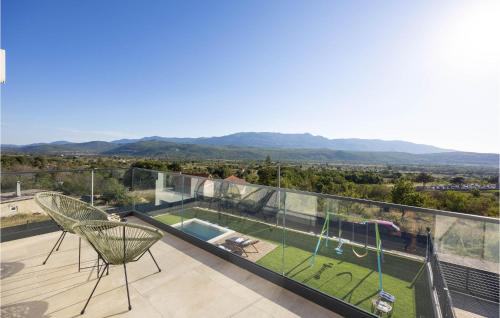 a house with a balcony with a swing at Luxurious Home In Dicmo in Dicmo