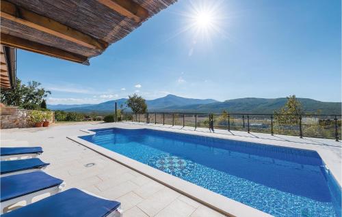 a swimming pool with a view of the mountains at Four-Bedroom Holiday Home In Kijevo in Kijevo