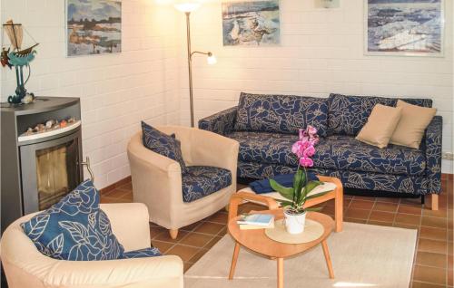 a living room with a couch and chairs and a table at 2 Bedroom Amazing Apartment In Koserow in Ostseebad Koserow