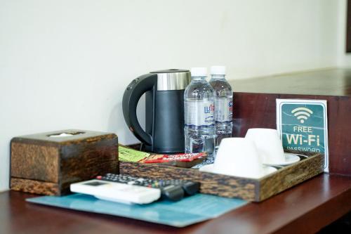 a table topped with a coffee maker and a coffeeicter at Angkearboss Villa in Kampot