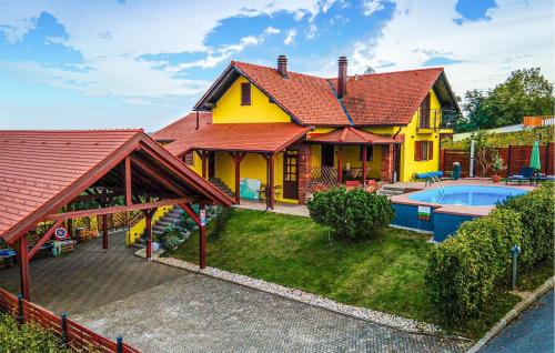 a yellow house with a swimming pool in front of it at Nice Home In Sedlarica With Sauna in Sedlarica