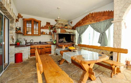 a kitchen with a wooden table and a wooden bench at Nice Home In Trogir With House Sea View in Trogir
