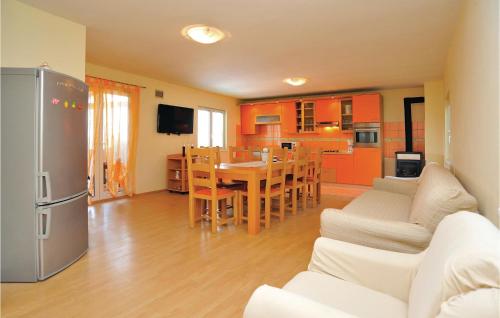 a kitchen and living room with a table and a refrigerator at Two-Bedroom Holiday Home Krusevo With An Outdoor Swimming Pool 04 in Kruševo
