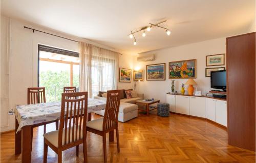 a living room with a table and a dining room at Holiday Home Rtina 24 in Rtina