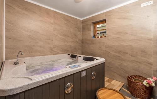 a bathroom with a large tub in a room at Stunning Home In Mrkopalj With Sauna in Mrkopalj