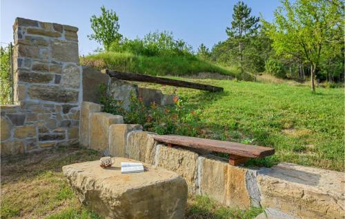 a bench sitting on a stone wall next to a field at Cozy Apartment In Cerovlje With Wifi in Cerovlje