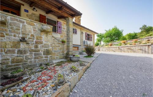 a house with a stone wall next to a street at Cozy Apartment In Cerovlje With Wifi in Cerovlje