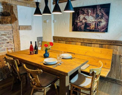 a wooden table in a restaurant with chairs and ahibition at BFC Ferienwohnung in Freudenstadt-Grüntal in Freudenstadt