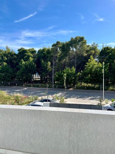a parking lot with cars parked in a parking lot at Xhefri's Apartments in Vlorë