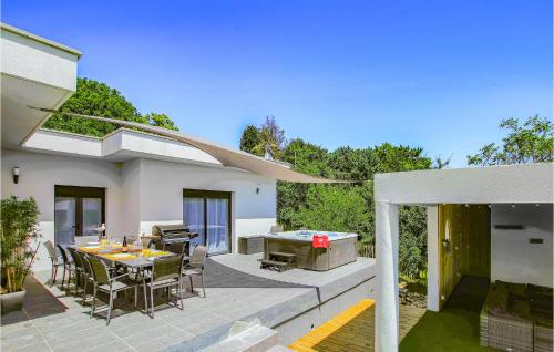 a patio with a table and chairs and a grill at Beautiful Home In Montélimar in Montélimar