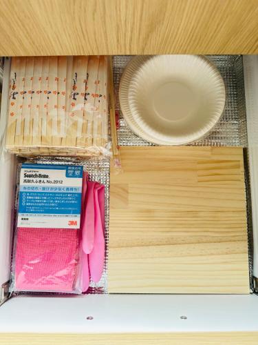 a drawer with a plate and a plate in it at MA House in Osaka