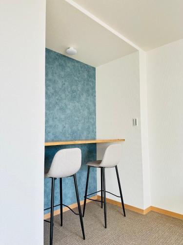 a table and two chairs in a room at MA House in Osaka