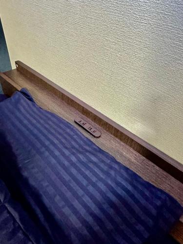 a close up of a blue bed with aedes at MA House in Osaka