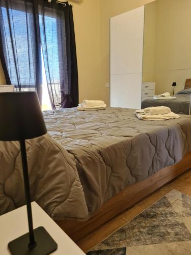 a bedroom with a large bed with a lamp on a table at Richard's Living in Xewkija