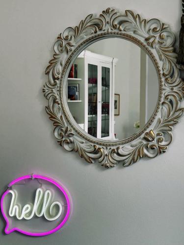 a mirror on a wall with a sign in front of it at Thalgiron, a breath away from Delphi in Ámfissa