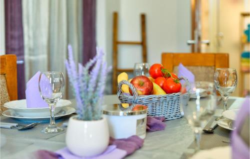 a table with a basket of fruits and vegetables on it at Lovely Home In Gornja Reka With Wifi in Lokošin Dol