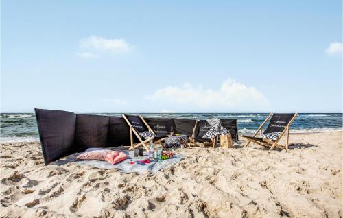 a group of chairs sitting on the beach at 3 Bedroom Gorgeous Home In Podamirowo in Podamirowo