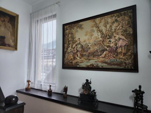 a large tapestry hanging on a wall in a room at Pensiunea Iris in Sighetu Marmaţiei