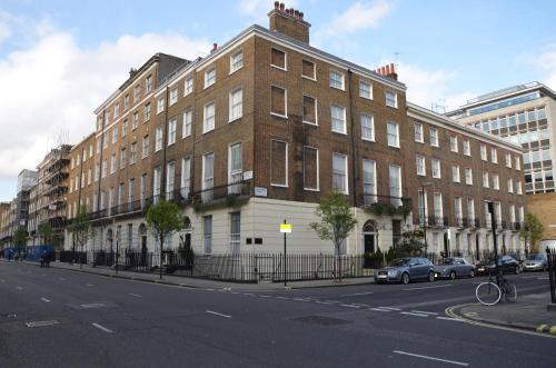 a large brick building on the side of a street at Amber Residence Hotel-Suites in London