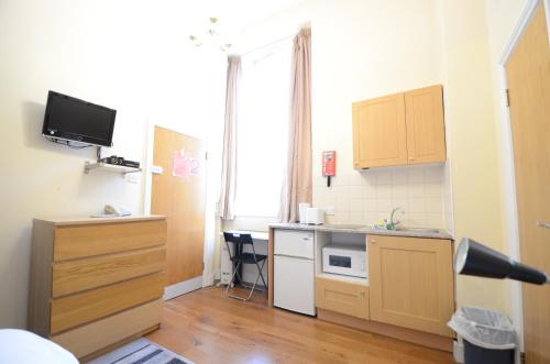 a small kitchen with a sink and a counter at Amber Residence Hotel-Suites in London