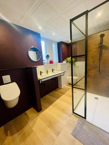a bathroom with a shower and a toilet and a sink at Pension Kirschberg in Bretleben