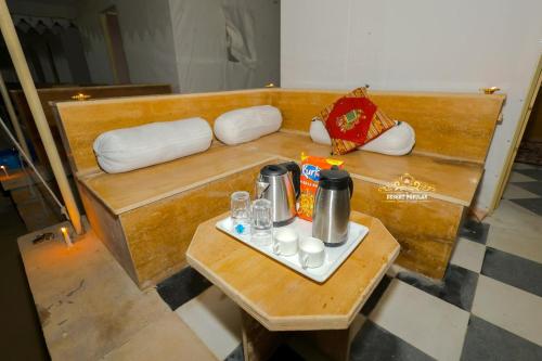 a small wooden table with a tray of food on it at Desert Popular Resort & Camp in Jaisalmer