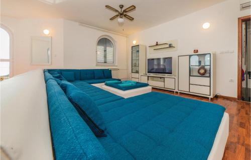 a large blue couch in a living room at Gorgeous Home In Povljana in Povljana