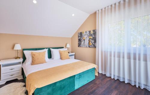 a bedroom with a bed and a large window at Cozy Home In Gornja Stubica With Sauna in Gornja Stubica