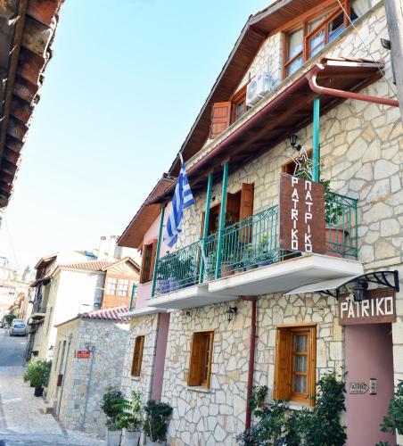 a building with a balcony on the side of it at Patriko in Arachova