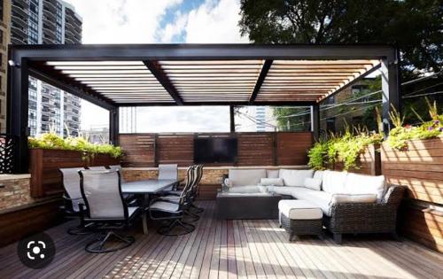 a patio with a couch and a table and chairs at Hotel Grand Ansara Mentari in Baturaja