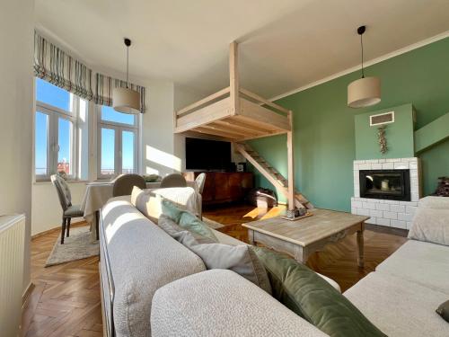 a living room with a couch and a fireplace at Apartament Ratuszowy in Cieszyn