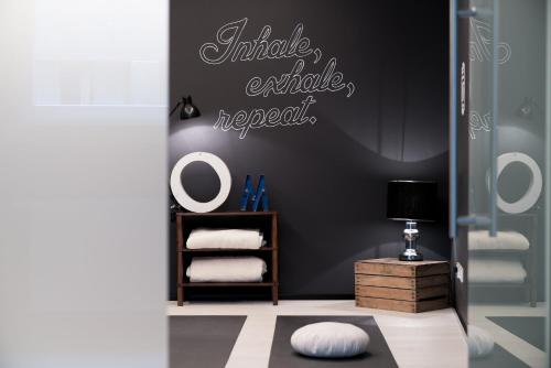a bathroom with a mirror and a shelf with towels at Ruby Marie Hotel Vienna in Vienna