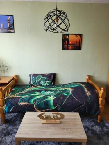 une chambre avec un lit et une table en bois dans l'établissement Studio Colmar, à Colmar