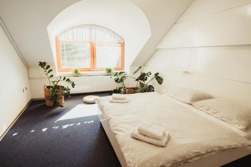 a bedroom with a bed with two towels on it at Hotel U Racka in Ostrožská Nová Ves