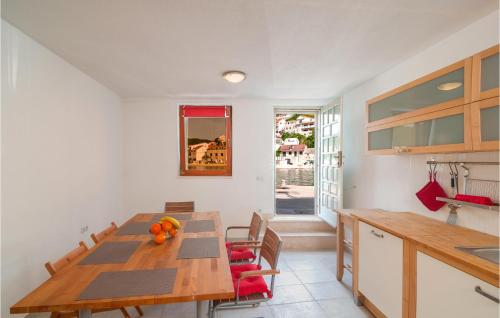 a kitchen with a wooden table and some chairs at Gorgeous Home In Pucisca With Wifi in Pučišća