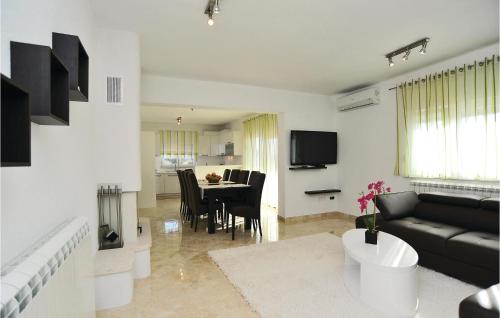 a living room with a black couch and a table at Holiday Home Pakostane 25 in Pakoštane