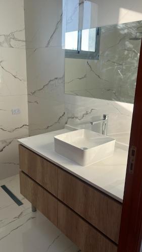 a bathroom with a white sink and a mirror at Casa Borges in Paraná