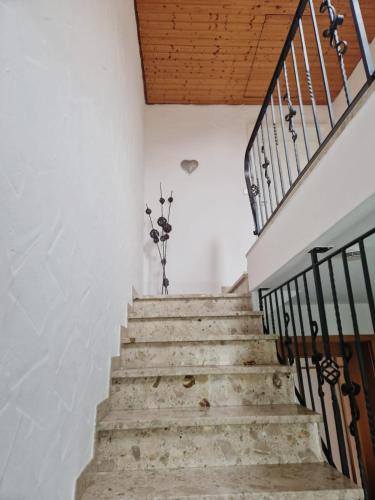 a staircase in a house with a wooden ceiling at FeWo Stauber in Amtzell