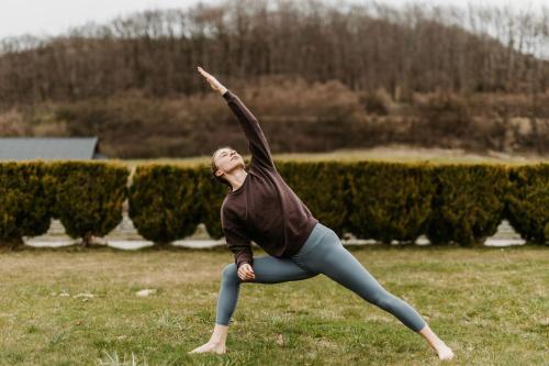 a woman standing in a field with her arm in the air at Dosłońce Resort Wellness & Farm in Racławice