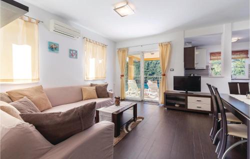 a living room with a couch and a table at Apartment Labin Lxxxi in Labin
