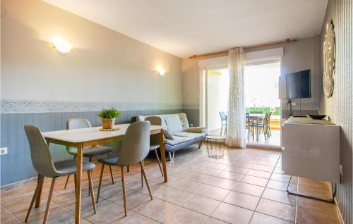 a living room with a table and chairs and a couch at Nice Apartment In Xeraco With Wifi in Xeraco