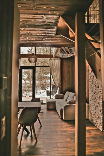 a living room with a bed and a couch at Bobrí potôčik in Liptovský Mikuláš