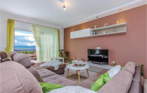 a living room with a couch and a tv at Amazing Home In Smrika With Sauna in Šmrika