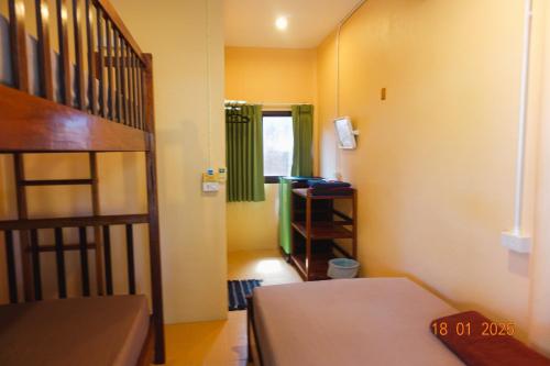 a room with a bunk bed and a ladder at Subsavet Village in Baan Tai