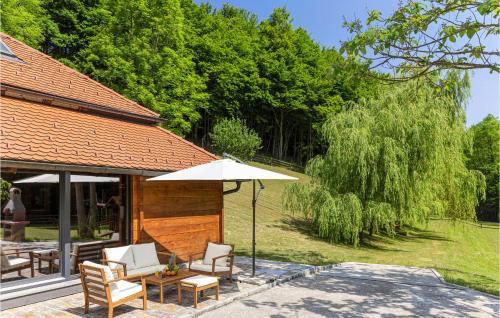 a patio with a table and an umbrella at Cozy Home In Vitesinec With Sauna in Salinovec