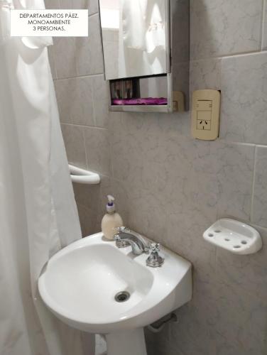 a bathroom with a white sink and a mirror at Departamentos PAEZ in Malargüe