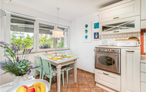 a kitchen with a table and a stove top oven at Lovely Apartment In Rijeka With Wifi in Rijeka