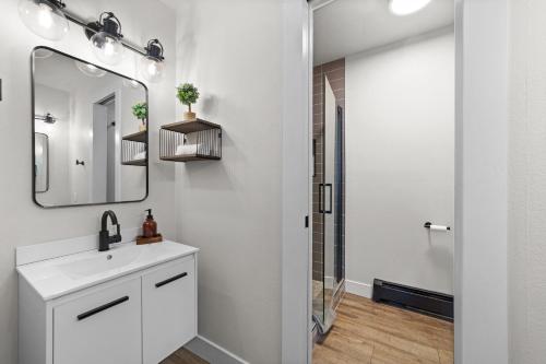a bathroom with a sink and a mirror at Canyon Retreat with Hot Tub 3min to Broadmoor in Colorado Springs